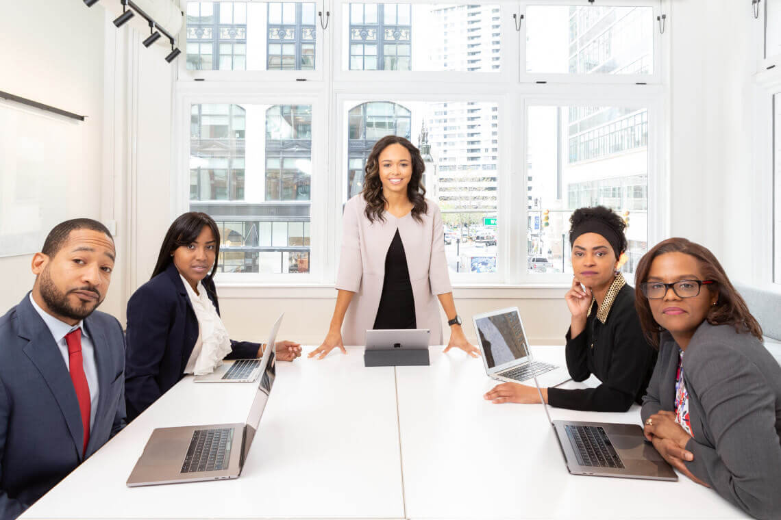 Woman Standing on the Center Table with Four People on the Side